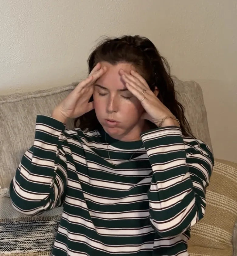 Woman holding her head, tired